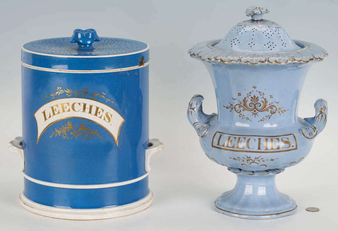 2 Staffordshire Apothecary Jars, Leeches: 1st item: Blue English Staffordshire cylindrical apothecary jar with "LEECHES." label in a white swag banner with gilt lettering. Exterior has two white handles and a perforated Ma