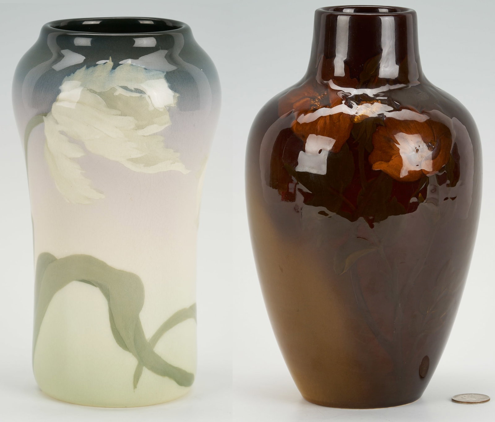 2 Rookwood Pottery Vases: 1st item: Rookwood Art Pottery vase, in the blue/green Iris glaze with white floral decoration to the body. Base with date mark of 1908, shape mark 935, size mark C, and artist's initials LA for L