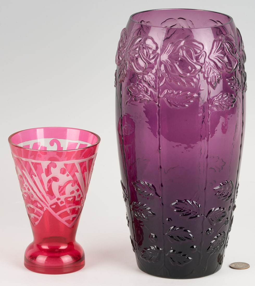 2 Art Deco Style Glass Vases incl. Nancy: 1st item: Cristalleries de Nancy Art Deco cranberry glass vase, beaker form with acid-etched frosted geometric design. Signed to base. 6 in. H. 2nd item: Amethyst glass tall vase with repeating blown-
