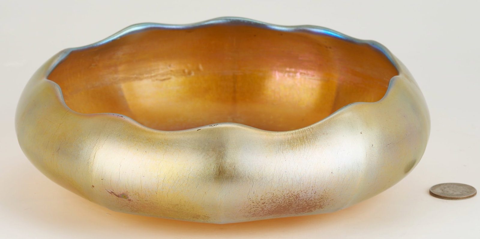 Steuben Aurene Gold Iridescent Art Glass Bowl: Steuben Aurene gold iridescent art glass low bowl with undulating rim and wide ribbed sides, signed Aurene to the underside and numbered. 8 1/2 in. diameter. American, early 20th century.&n