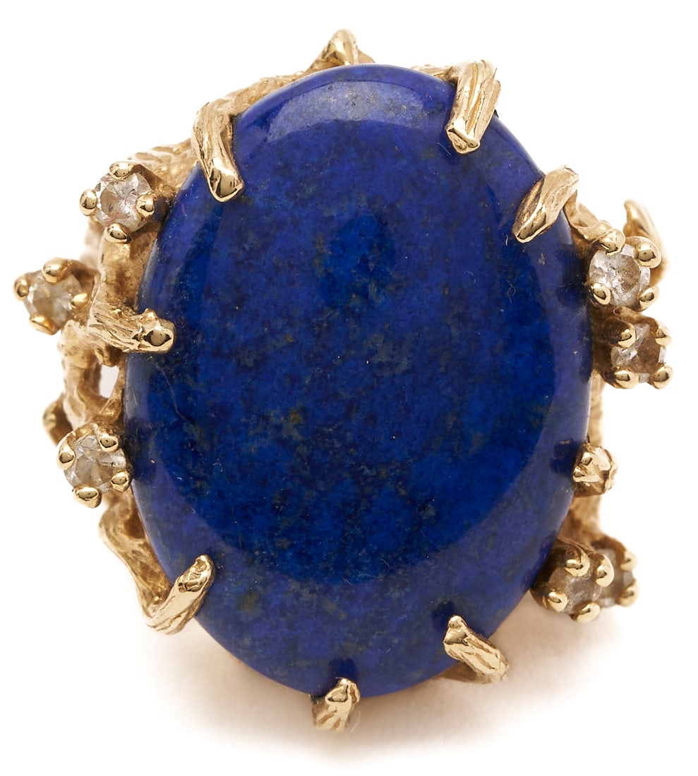 Lapis Lazuli & Diamond 14K Gold Ring: Ladies' 14K gold ring featuring a lapis lazuli cabochon measuring 24 x 17 1/2 mm accented by 7 round cut diamonds weighing .35 carats. Size 7. 15.66 total grams. Additional high-resolution ph