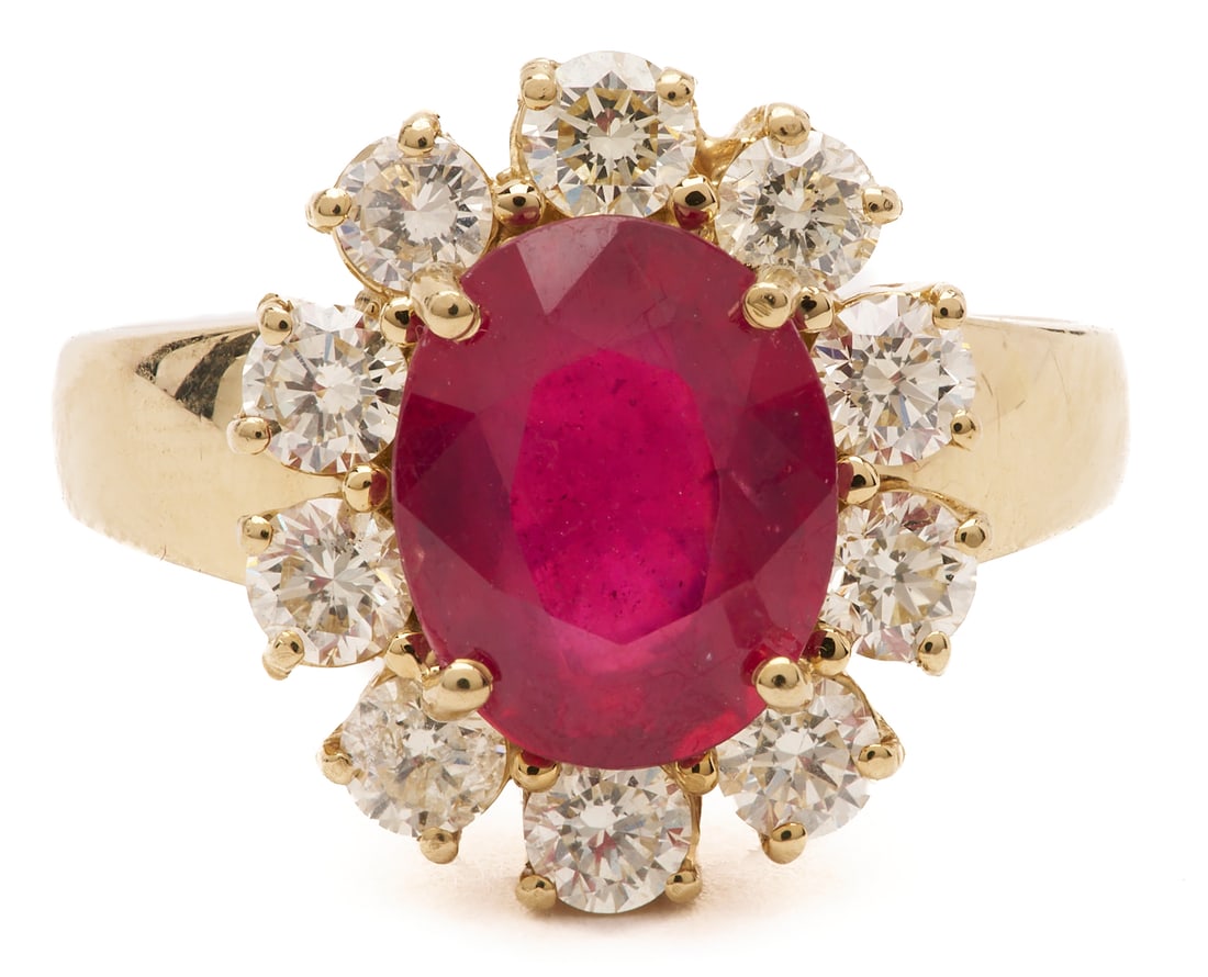14K Ruby and Diamond Ring: 14K yellow gold ruby and diamond ring, featuring an oval 10 x 8 mm red leaded glass hybrid ruby set at the center. Accented by ten (10) round full-cut diamonds totaling approximately 1.40 carats,