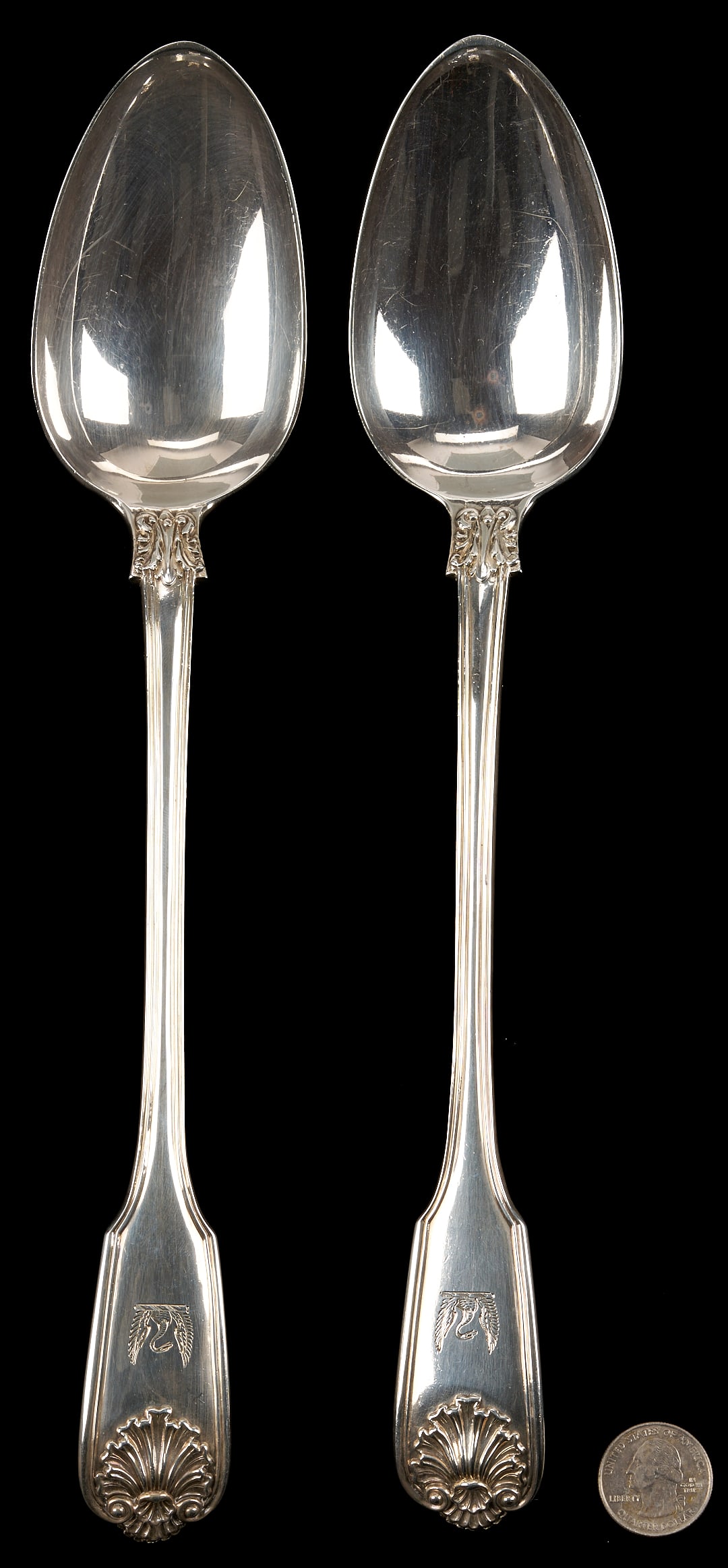 Pair English Basting or Rice Spoons: Pair of large and heavy William IV sterling silver basting or stuffing spoons with well defined shell, thread and fiddle handles, with scroll decoration at necks and shells to reverse of bowls.