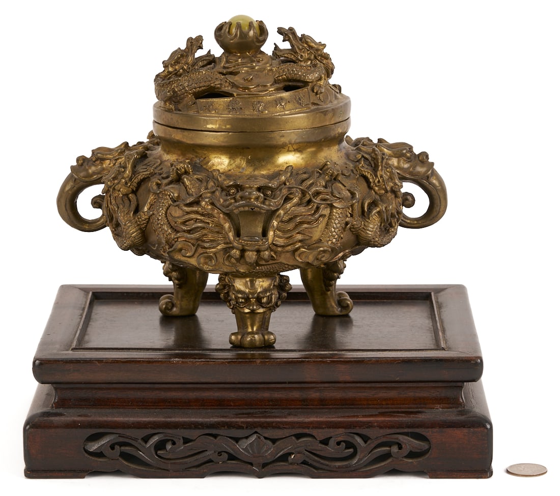 Chinese Bronze Censer w/ Hardwood Base: Chinese bronze dragon decorated censer, having a pierced cover with hardstone "pearl" finial, pursued by figural dragons, with raised Chinese symbols; two figural dragon tongue handles, and