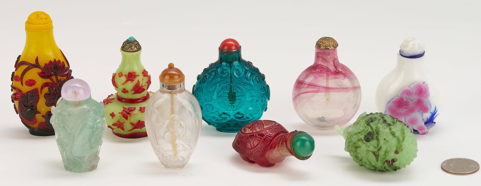 9 Chinese Glass Snuff Bottles incl. Peking Double Gourd: Nine (9) Chinese glass snuff bottles, including 1 yellow glass with ruby red overlay decoration with flowers and bats, and a stopper carved in the form of a figural ox; 1 green glass double gourd