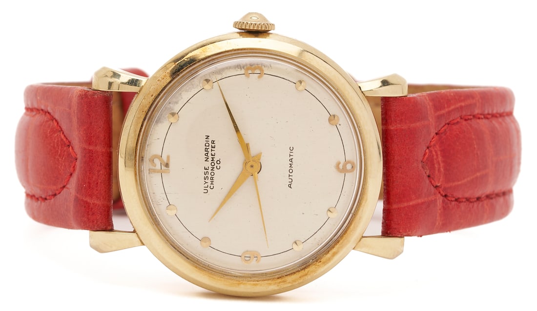 14K Ulysse Nardin Chronometer Watch: 14K yellow gold Ulysse Nardin Chronometer watch, silvered watch face with gold markers, manual-winding mechanical movement, 33mm case, red-orange lizard leather band. 9 in. L. Additional