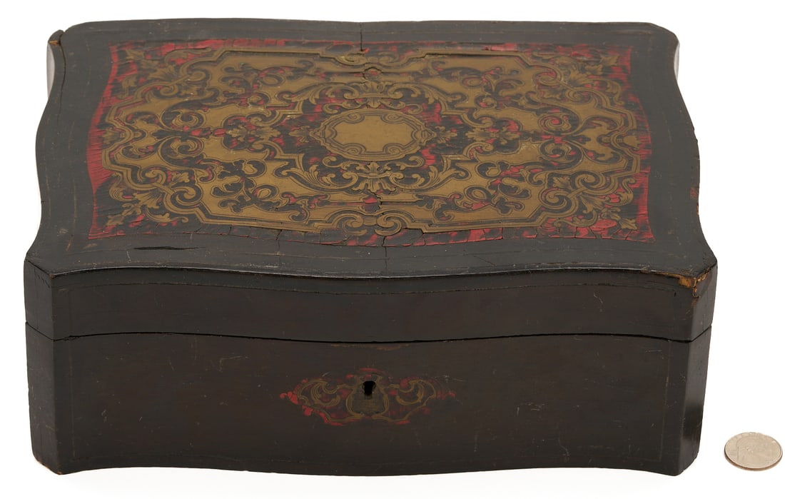 French Boulle Vanity Box: French Boulle marquetry vanity box consisting of a shaped lid with foliate brass inlay set against a red background above a conforming ebonized case with a fitted velvet interior including a mirr