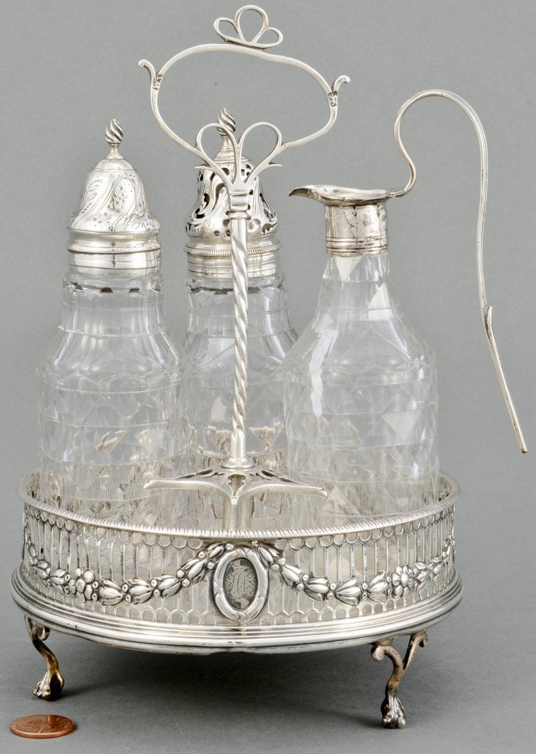 George III Sterling Cruet Frame and Bottles: George III Sterling Silver cruet frame and bottles. Neoclassical style frame with twisted handle over a circular base with reticulated sides, adorned with cast floral garland swags and medallions, rai