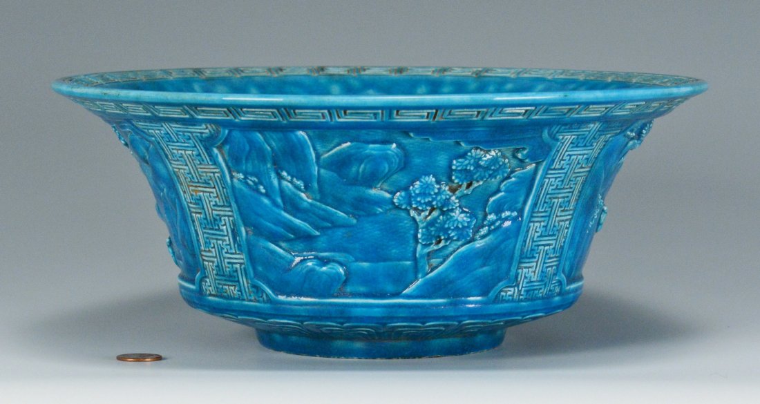 Chinese Blue Glazed Bowl: Chinese turquoise or peacock blue glazed pottery bowl with relief decorated rim and body. Ch'ien seal form mark to base. 4-1/2" H x 11-1/8" dia. 20th century. Provenance: a Nashville estate.