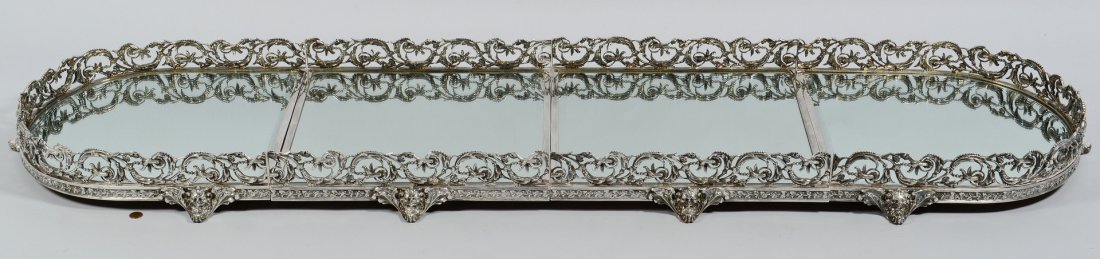 4-piece Silverplated Plateau: Large silverplated plateau. Made in four sections with pierced animal and foliate carvings, ten winged masked paw feet, beveled mirrored tray and wooden base with wooden peg supports. 66" x 16-1/4" ov