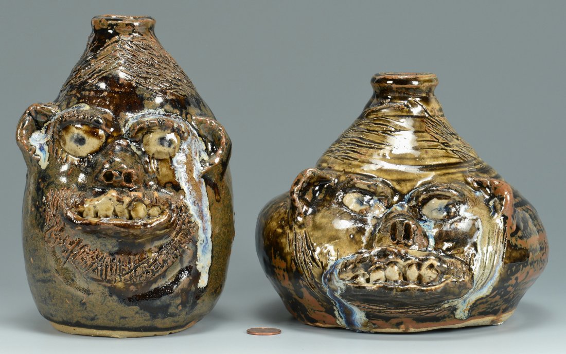 2 Georgia Folk Face Jugs, Marie Rogers: Two Georgia folk pottery face jugs by Marie Rogers (Meansville, GA), both with rutile drip, one with squat shape, 5-1/2" H, the other more cylindrical, 7" H, both signed in script on bottom.