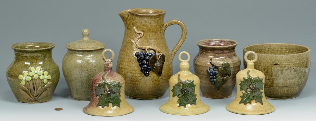 Group of Anita Meaders Pottery, 8 pcs.: Group of Anita Meaders folk art pottery, all signed on base including alkaline glazed and drip glazed pieces, most with applied decoration including pitcher, 2 vases, lidded jar, bowl and three bells 
