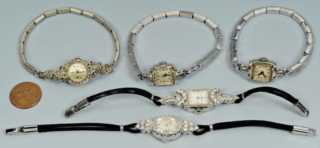 5 Ladies Vintage Wrist Watches: Group of 5 Ladies vintage watches. 1st item: Lady's Croton 14k white gold and diamond wristwatch with oval face and containing approximately 1 ct diamonds, with black strap. 2nd item: Lady's 10k (test