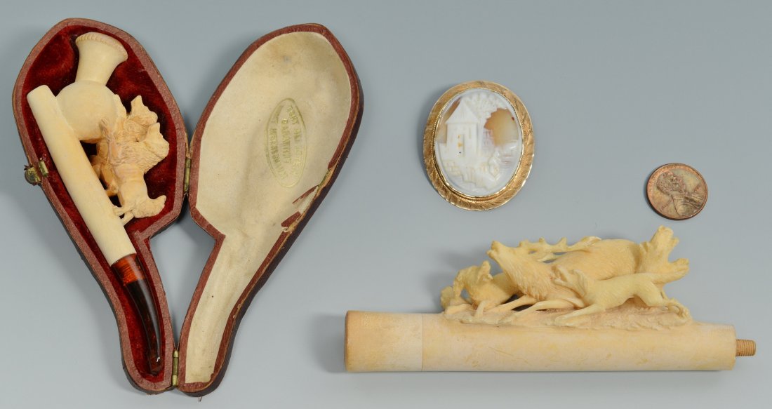 10K cameo and 2 Meerschaums: One 10K yellow gold shell cameo pin/pendant of village scene, 1-3/4" H x 1-1/2" W, 0.33 grams; one Meerschaum pipe with pair of dogs in fitted case, 5" L; one Meerschaum stem with stag and two dogs, 4