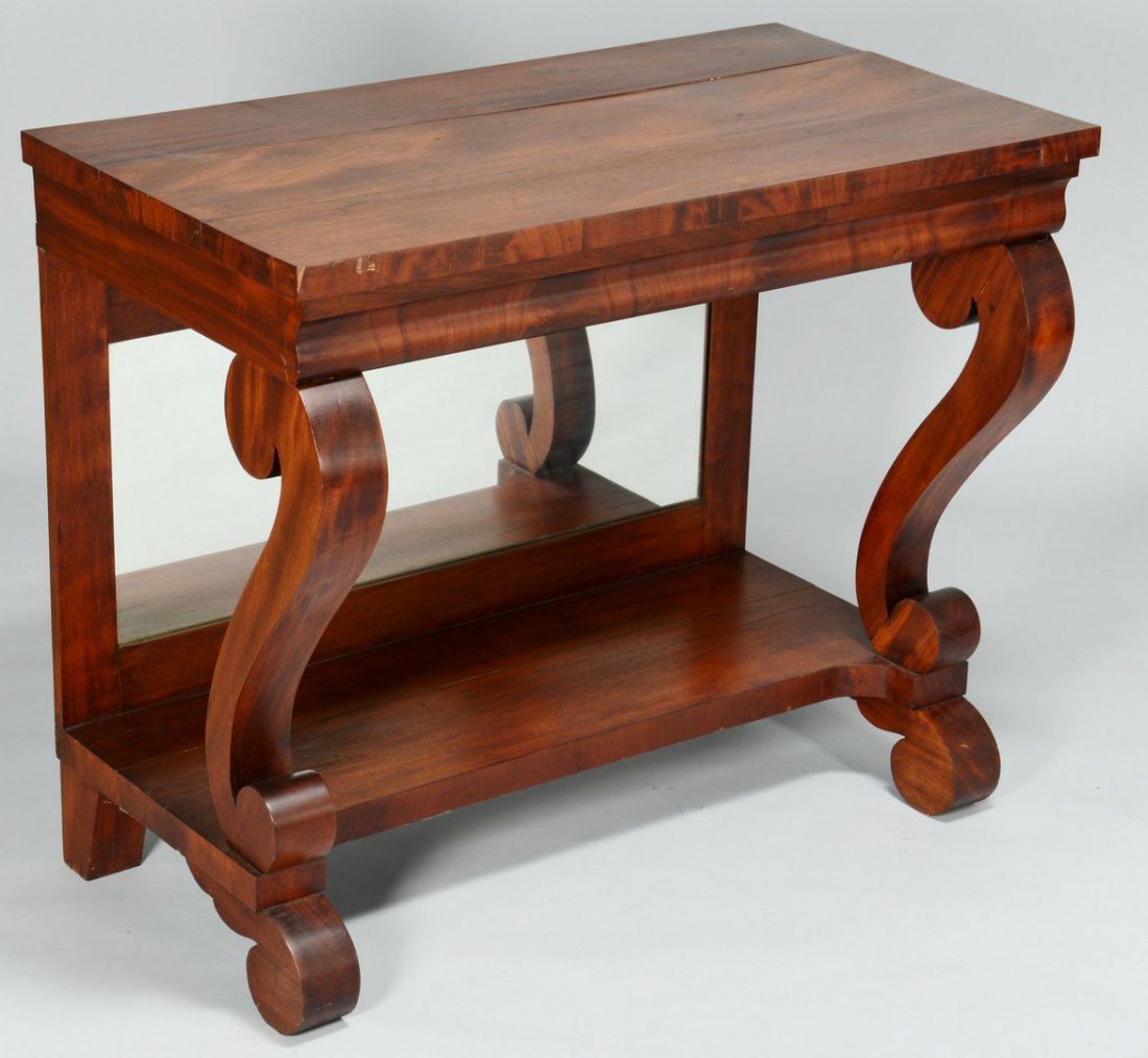 Empire Mahogany Pier Table: American Empire or Late Classical pier table. Mahogany and mahogany veneers, ogee shaped apron, scroll shaped columns, concave base, and scrolled feet. 35 3/4"H x 42 1/4"W x 23"D. Provenance - Estate 
