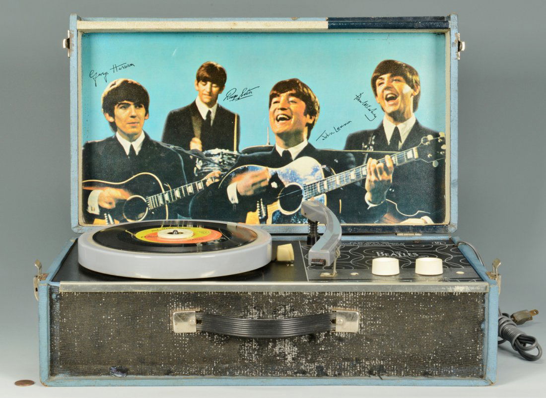1964 Beatles Record Player NEMS & one 45 record: 1964 Beatles NEMS record player housed in a blue cabinet with four-speed turntable. Retains the two original photos of the Beatles including the smaller outer lid photo depicting the group seated, and