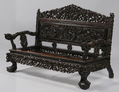 Chinese Hardwood Export Settee: Elaborately carved Chinese export hardwood settee, the crest with dragons flanking a central carved vignette of rats among berries, the back support with two fan-carved vignettes of monkeys, deer,