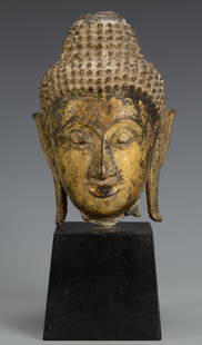 Gilt Bronze Buddha Head: Asian gilt bronze Buddha head fragment, mounted on wood base, possibly 18th century/Early 19th century. 6 1/4" H. Height with stand - 9 3/4".