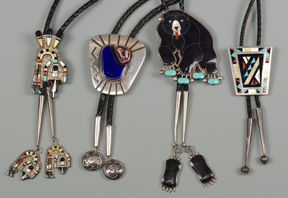 4 Signed Native American Bolos: Four signed Native American silver bolo ties with leather bolos. 1st item: Jerry Johnson, Navajo Sterling bolo tie with two stones and geometric designs signed "JJ", the bolo with sterling tips. 2nd i