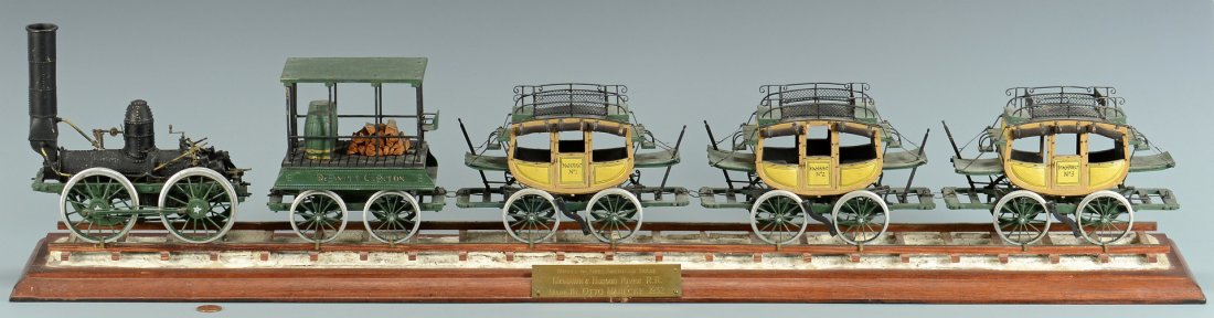 1933 Dewitt Clinton Model Passenger Locomotive, Award: A mechanical scale model of the wood-burning DeWitt Clinton steam engine locomotive and three passenger coaches, comprised primarily of painted wood, tin and brass. The DeWitt Clinton was the first Am