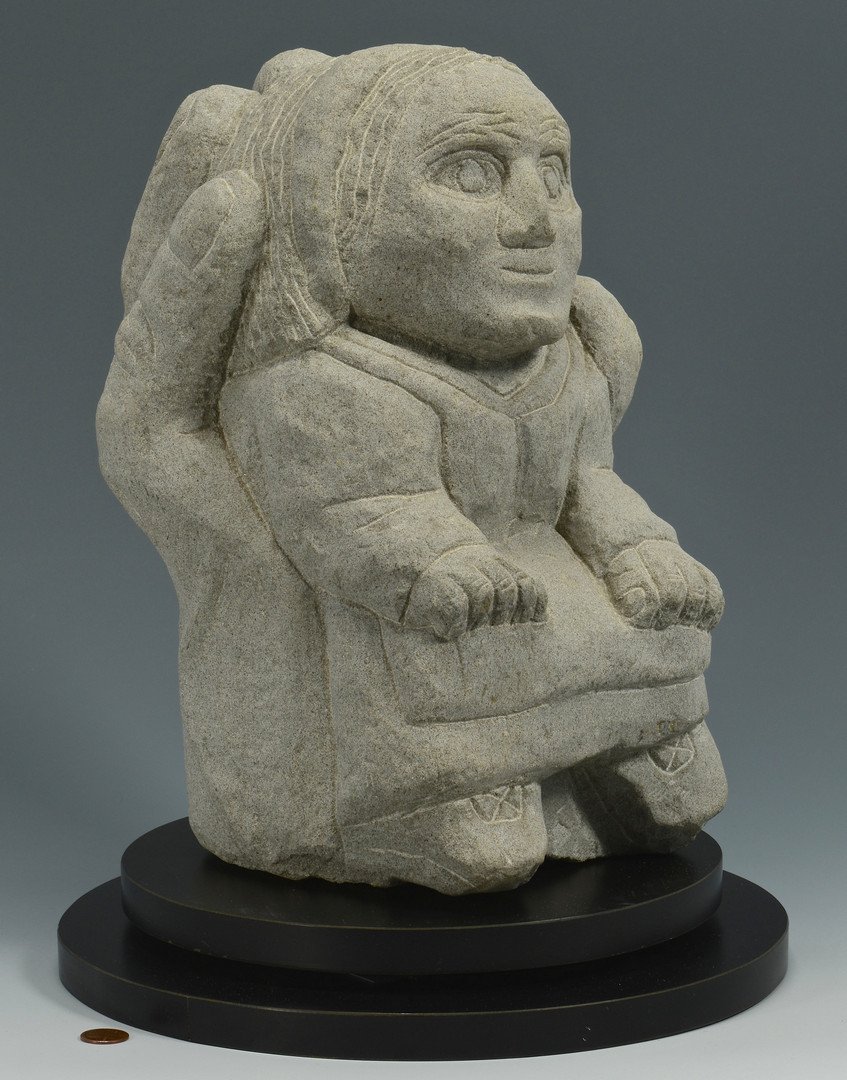 Tim Lewis Limestone sculpture: Tim Lewis (Kentucky, b. 1952) folk art carved limestone sculpture of a figure being held in a large hand. Signed on back and dated T. Lewis '96. 13"H. Provenance: the collection of Stephen and Lisa St