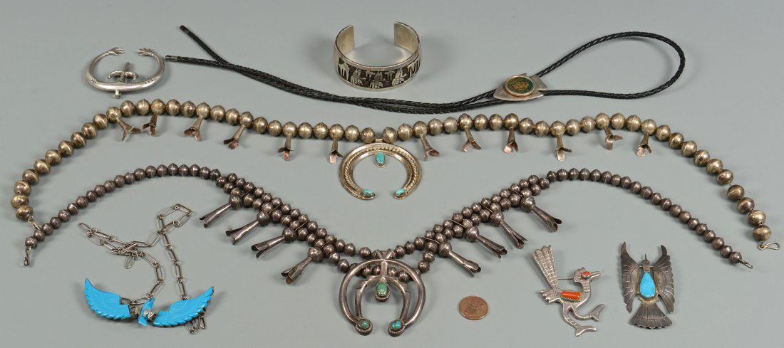 8 Native American Jewelry Items: Eight (8) Native American silver jewelry items including two (2) silver squash blossom necklaces with turquoise stones, two silver bird pins with turquoise stones, silver clip with hand chased decorat