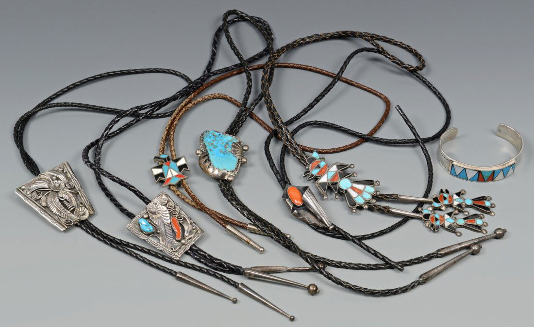 6 Bolos and a Zuni Bracelet: 7 pieces of Southwestern Native American jewelry, including 1 Zuni silver and enamel bracelet and 6 bolo ties: 1 Zuni enamel with mother and children figures, 1 Zuni enamel bird, 1 with silver colored
