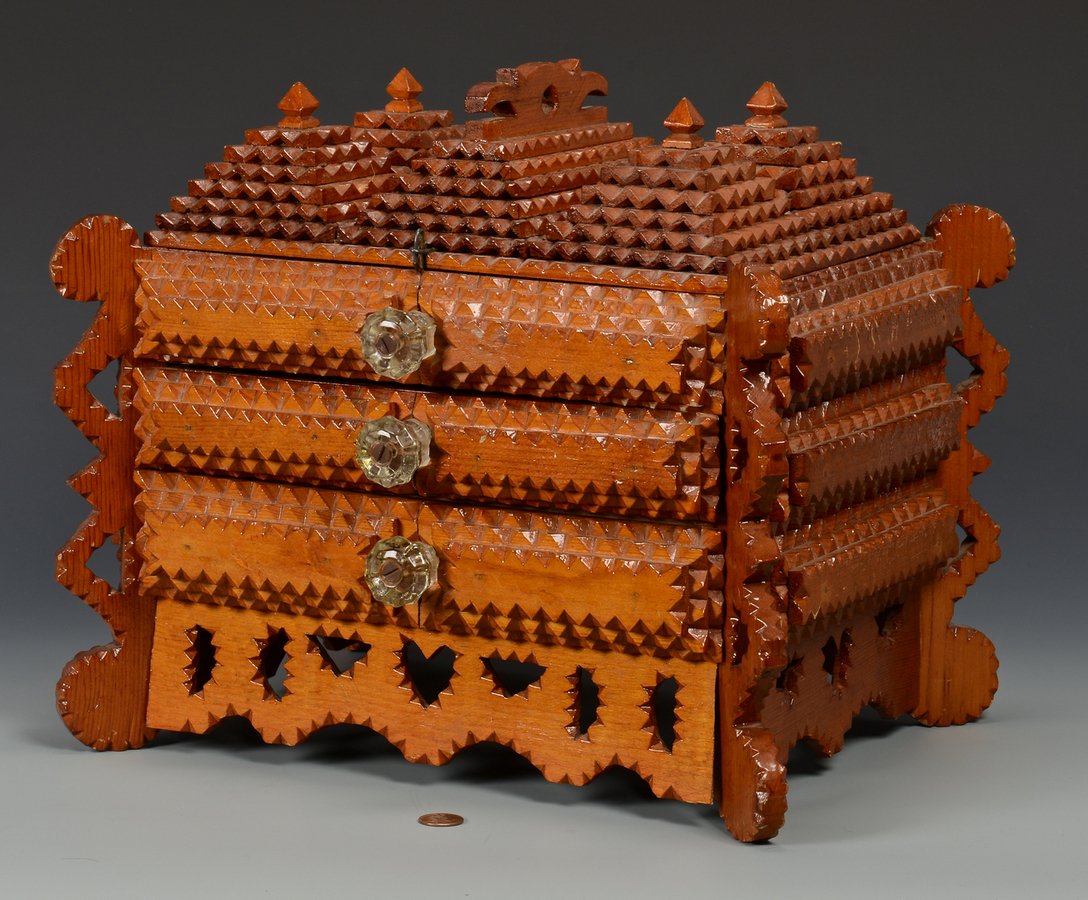 Large Tramp Art Sewing Box: Large Tramp Art sewing box with elaborate stepped multi-triangle hinged top, applied stiles and cut-out skirt with two drawers and glass knobs. 11 3/4" H x 14" W x 10" D. Early 20th century. Proceeds 