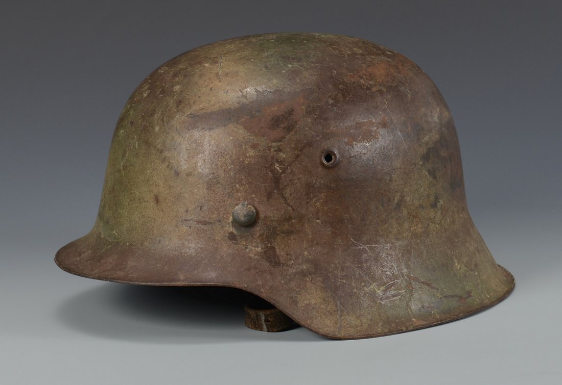 German M42 Helmet w/ Camouflage: World War II German M 42 Helmet with original camouflage paint, eight finger liner and suspension intact, and chinstrap. Name written in black script on liner, "Nermendeger" (sp). 6" H x 11 1/4" D x 7