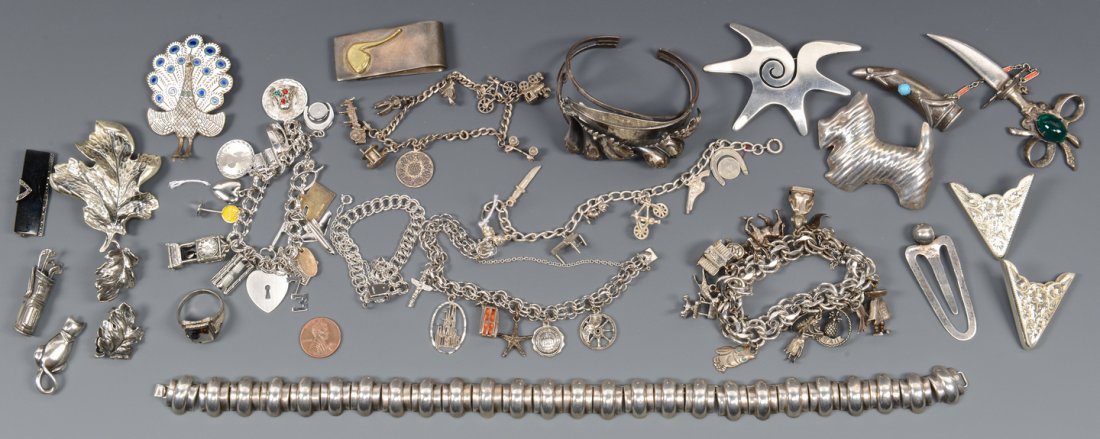 Sterling Charm Bracelets & Novelty Pins: A large assortment of sterling silver jewelry including Mexican necklace, Napier leaf pin and matching earrings, bracelet, collar tips, marcasite brooch and mixed metal tie clip with pipe, quartz ring