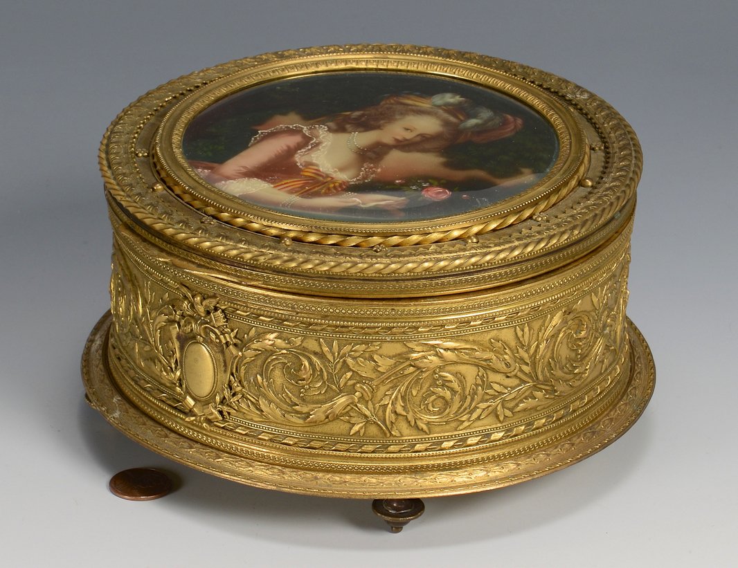 Signed Bronze Portrait Box: French bronze portrait box, round; the hinged top with hand painted portrait of lady in pink silk dress with lace collar and cuffs, yellow and red bow at bust, wearing a plumed hat and carrying a rose