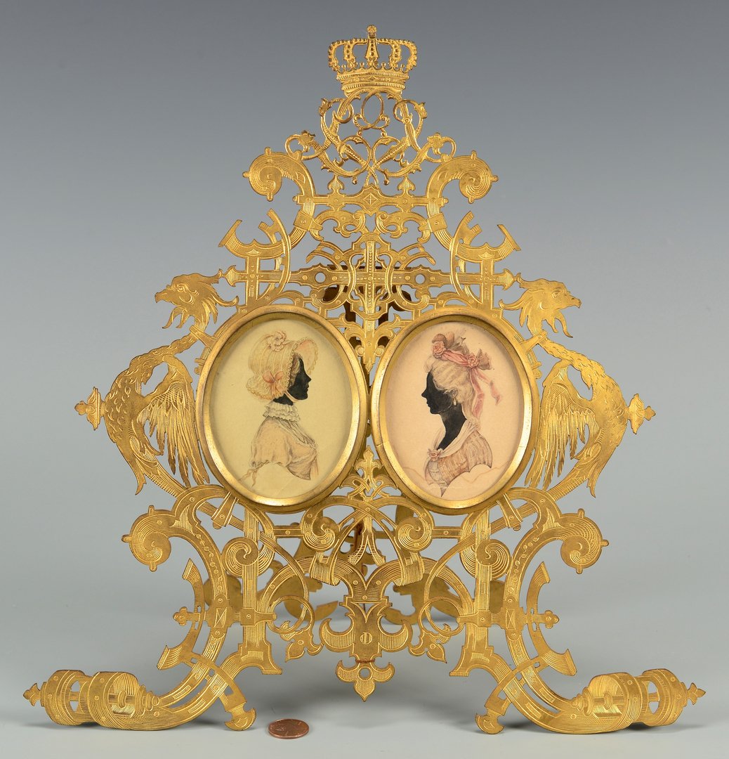 Prussian Royal Portraits, Princesses Louise and: A pair of Prussian Royal silhouette portraits, ink and watercolor, of Princess Louise and Princess Victoria; housed within an elaborate pierced gilt bronze easel frame with extensive engraving. Gothic