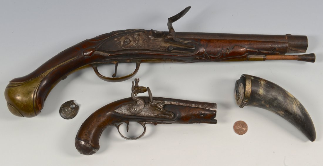 2 Continental Flintlock Pistols, Powder Horn: Grouping of two (2) Continental flintlock pistols and a small powder horn with silver inlay cap/plug. 1st item - Continental flintlock pistol with foliate carved forearm and upper tang, tapered barrel