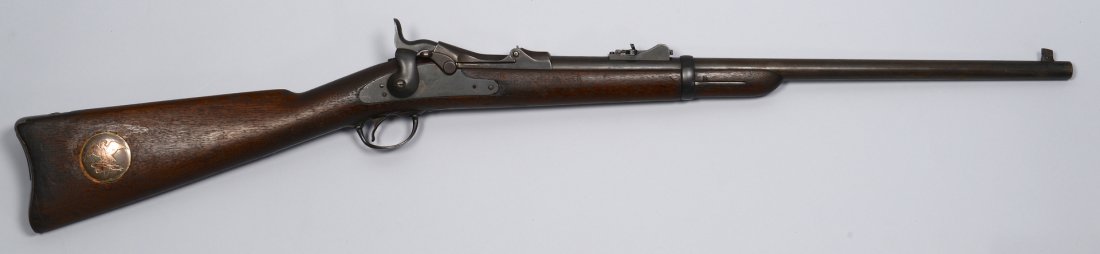 U.S. Model 1873 Springfield Carbine: Model 1873 "Trapdoor" Springfield Carbine, .47, serial #143002, with percussion action, adjustable rear sight and sling attachment on left of magazine. Stock is stamped with an image of an eagle, whil