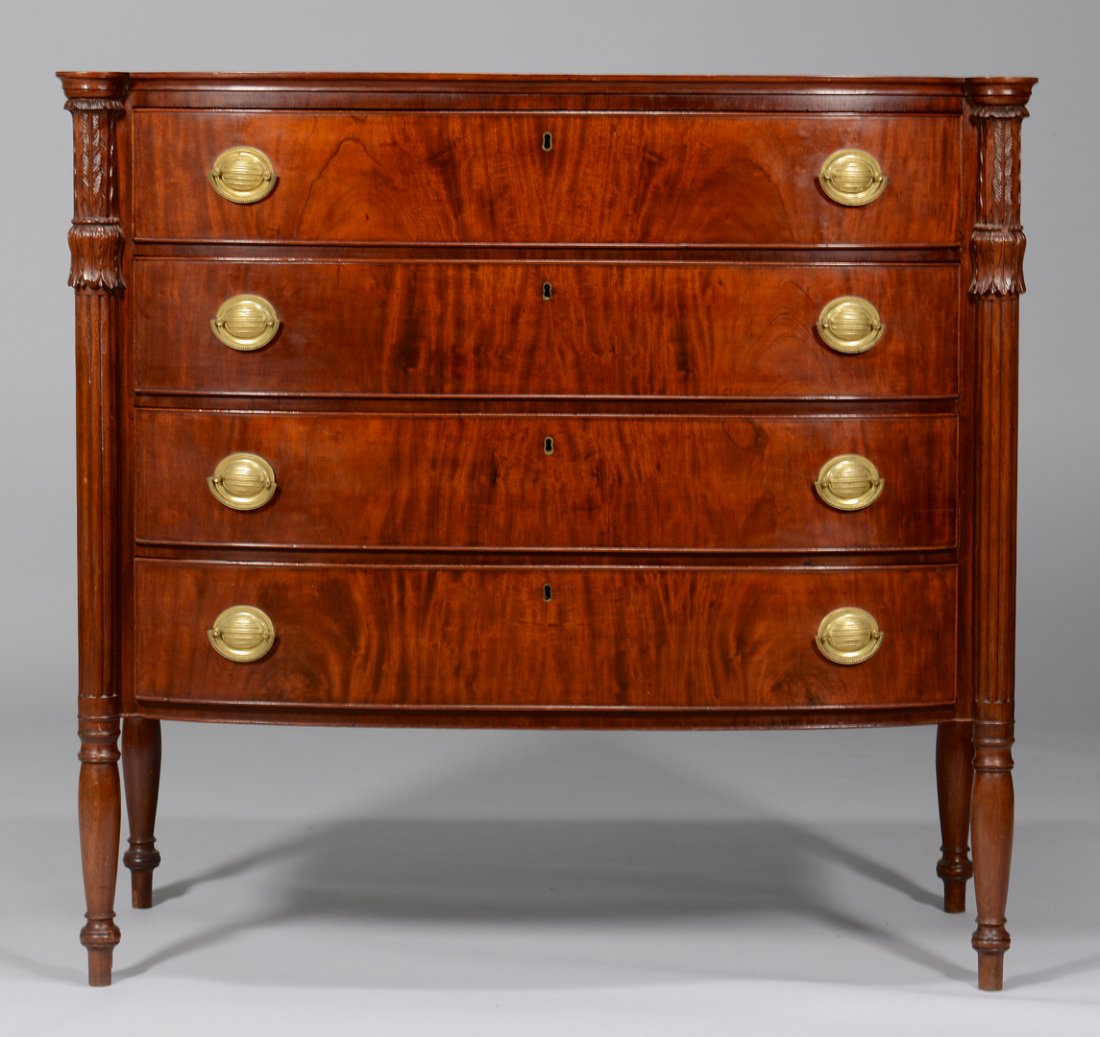 Federal Bowfront Chest of Drawers: Massachusetts Federal mahogany bowfront chest of drawers in the Sheraton style, four flame-veneered banded dovetailed drawers, turreted corners with carved acanthus leaf capitals and reeded pilasters 