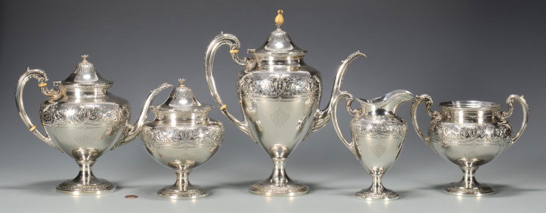 Reed & Barton Aesthetic Style Sterling Tea Set, 5 pcs.: Reed and Barton five (5) piece sterling silver tea set, pattern #920 C, consisting of teapot, coffee pot, sugar, creamer and waste bowl. Chased floral and cartouche decoration. Ranging in size from 6"