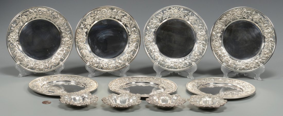 S. Kirk and Reed & Barton sterling: 1st group: Set of seven (7) S. Kirk & Son sterling silver Repousse bread and butter plates, marked "127F" on base, 6 1/4" diameter. 28.805 troy ounces. 2nd group: Set of four (4) Reed & Barton sterlin
