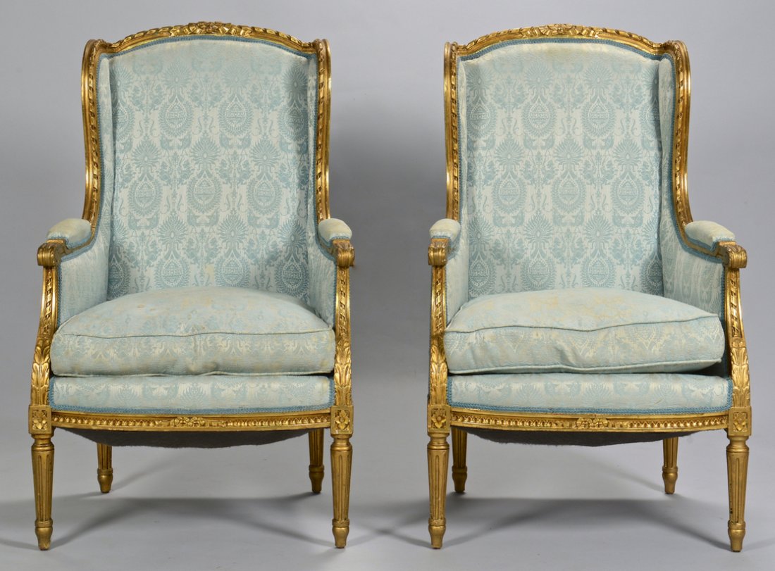 Pr. French Louis XVI Chairs w/ Gilt Carving: Pair Louis XVI style giltwood bergeres of diminutive size, in blue matelaisse upholstery; coil spring upholstered seat with separate seat cushion. 41" H x 25" W x 22" D overall x 18" seat H. Provenanc