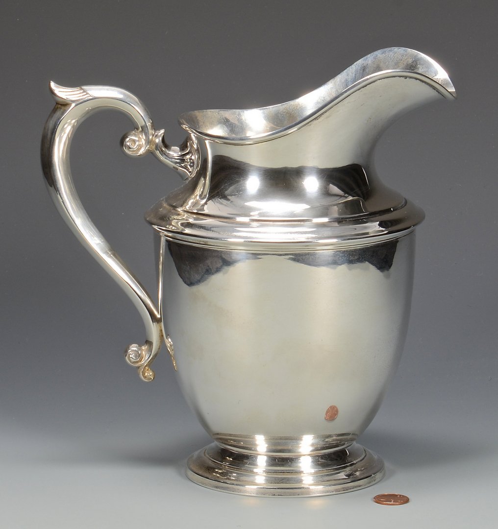 Art Deco Sterling Pitcher: American Art Deco period sterling silver water pitcher, helmet form with wing tip handle marked on base for Ellmore Silver Co. (Meriden, CT 1935-1960), 9-1/8"H. 23.62 oz troy. Circa 1935.