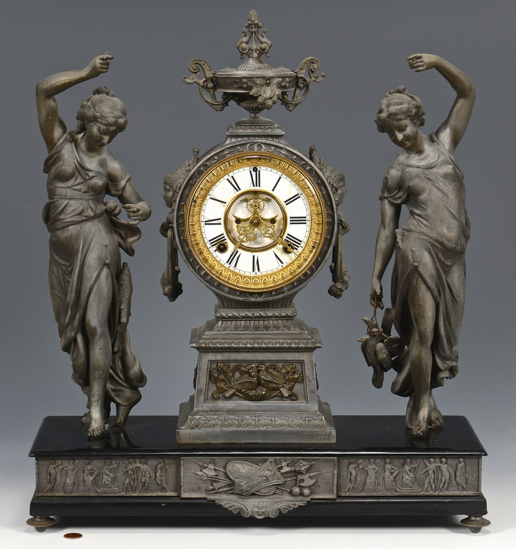 Ansonia Double Figural Clock, Fisher & Hunter: Ansonia double figural mantle clock titled "Fisher and Hunter", silver finish, porcelain dial with Roman numerals, time and strike, gong strike. Retains the original pendulum and key. Clock works mark