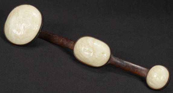 White Jade Ruyi Scepter, Qing: Chinese inlaid rosewood and white jade Ruyi scepter; the rosewood frame inlaid with silver wire floral decoration, and inset with three white jade plaques of graduated size, each profusely carved