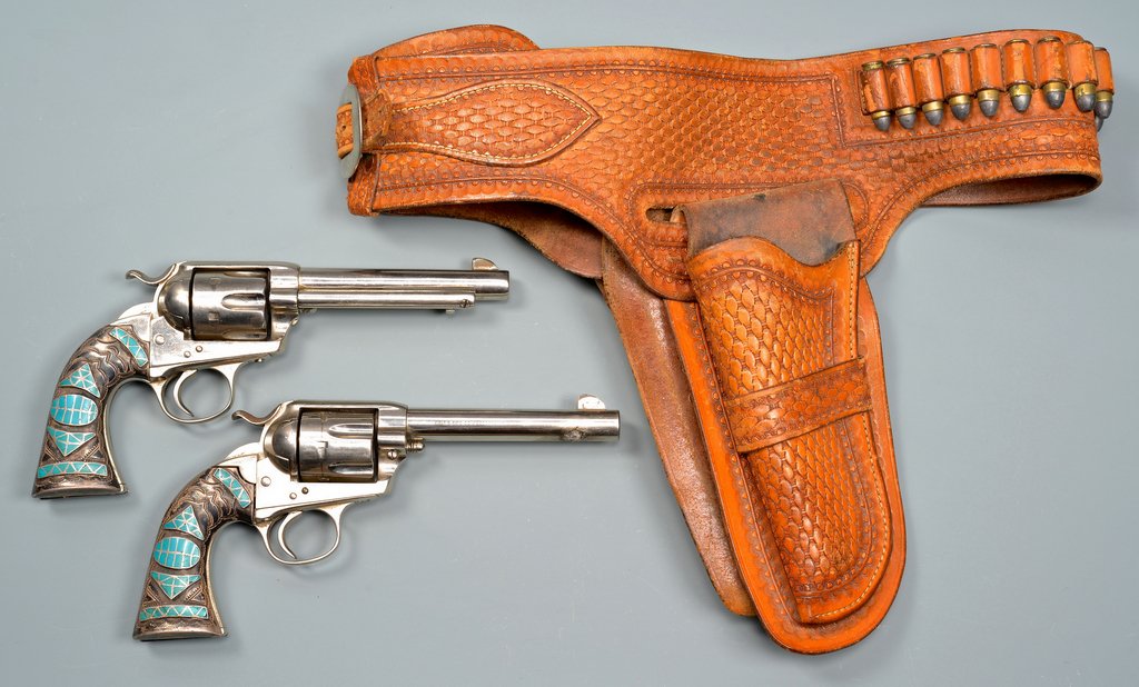 2 Colt Pistols, .45 Caliber w/ Turquoise Inlays with: Two Colt 45 caliber pistols with turquoise inlays, leather holster. 1st item: Colt single action army .45 caliber pistol, serial number 219987 (visible matching serial numbers), "Pat. Sept. 19, 1871 J