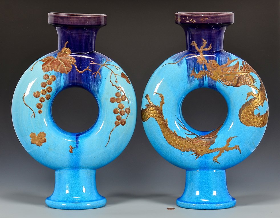 Pr. French Glazed Ceramic Flasks: Large pair of French glazed ceramic flasks, blue ground, one having applied gilt painted dragon decoration and the other with applied gilt painted grape and leaf design decoration. Remnants of gilt de