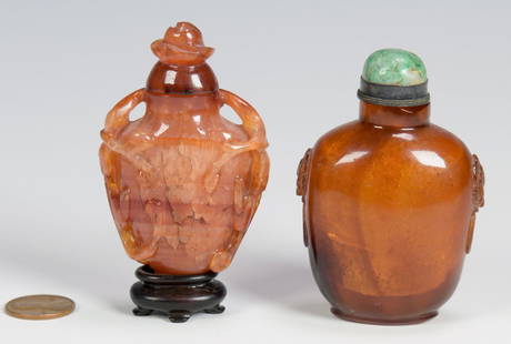 2 Chinese Snuff Bottles inc. amber: 1st item: Chinese hardstone snuff bottle, possibly carnelian, urn form with naturalistic carving, openwork at shoulder area, carved rose lid; 2 3/4" H (not including small hardwood stand, 1/2" H).