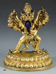 Large Bronze Tibetan Hayagriva Sculpture: Large Tibetan 2-part gilt bronze depicting Vajrabhairava with his consort or prajna on a double lotus plinth. Vajrabhairava depicted with eight faces, eighteen arms, each with object in hand, and