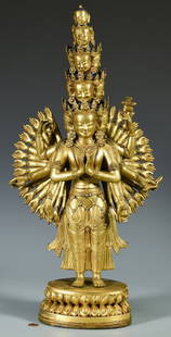 Gilt Bronze Jeweled Avalokitesvara Sculpture: Gilt Bronze Tibetan Avalokiteshvara sectional sculpture depicted with 11 faces and 42 arms with jeweled accents and applied blue pigment to hair standing atop a double lotus pedestal base. 23 3/4" H