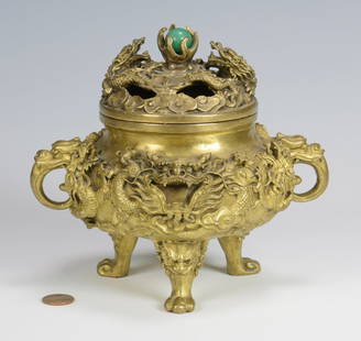 Chinese Gilt Bronze Dragon Censer: Chinese gilt bronze censer or incense burner, tripod footed form, the domed lid with figural writhing dragons surrounding a jade "pearl" finial, over a bulbous body with multiple relief carved