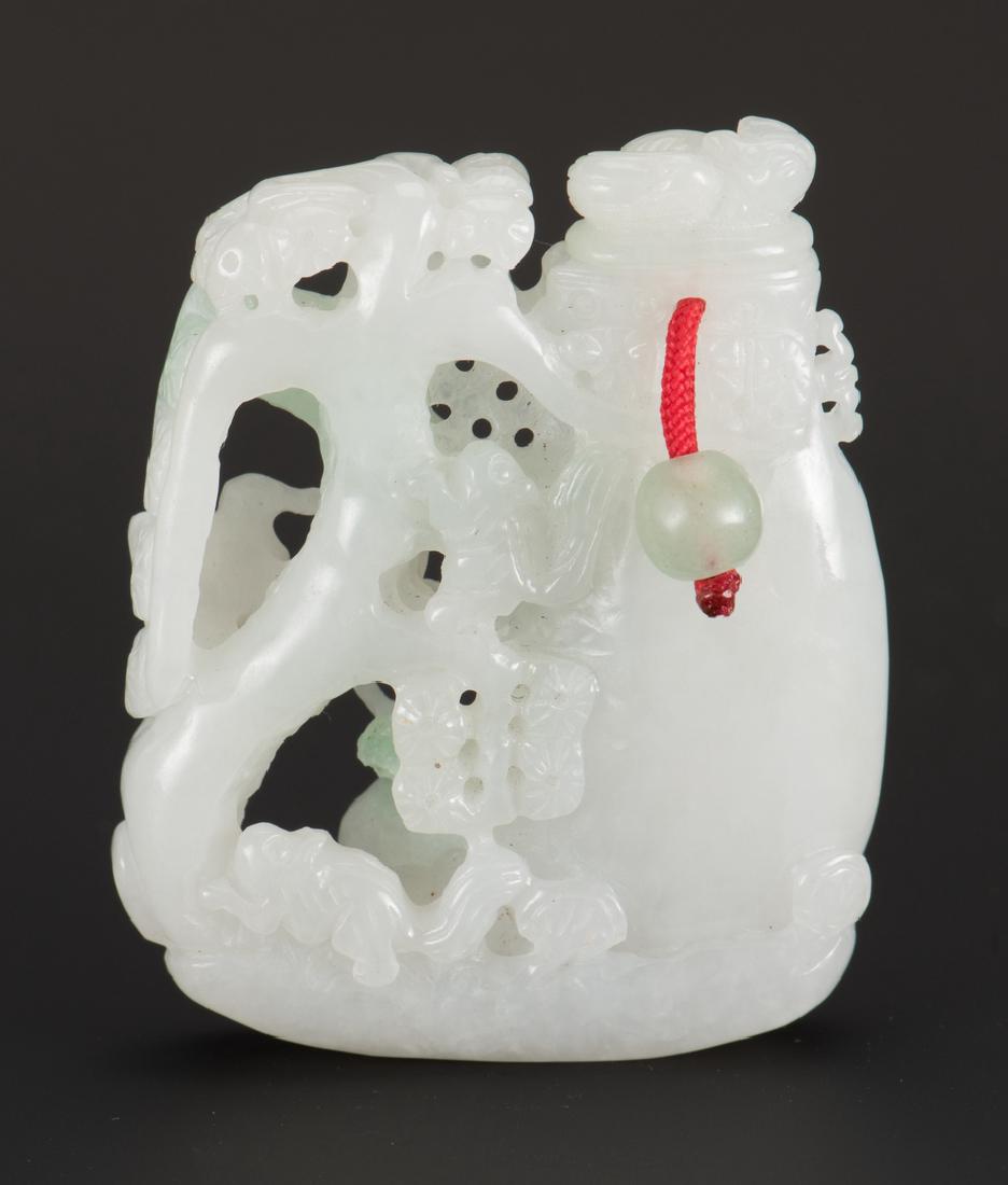 Jade Boulder Snuff Bottle: Carved green and white jade snuff bottle in the form of a vase, with adjacent flowering tree harboring birds and squirrels. Carved lid is attached by means of a cord with green hardstone balls at eith