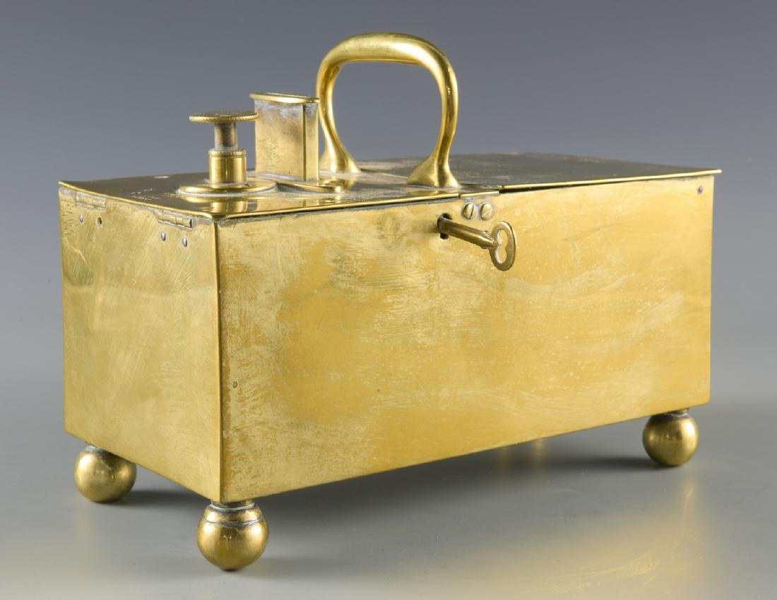 English "Rich's Patent" Brass Tobacco/Honor Box: English Rich's patent brass tobacco or honor box comprised of a rectangular case with rounded feet, two locking hinged compartments, one end with a coin slot and plunger, and center handle. Maker's ma