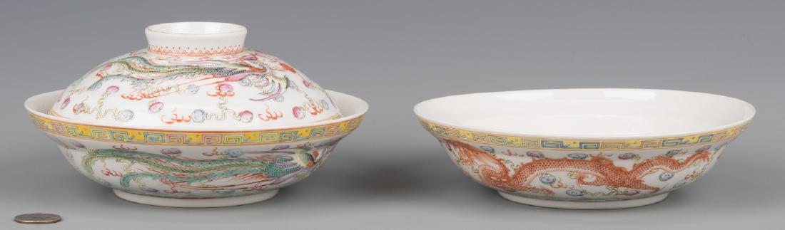 2 Chinese Porcelain Dragon Bowls: Pair of Chinese Famille Rose lidded porcelain bowls, the exterior with dragon chasing the flaming pearl decoration, a yellow ground multi-color fret border to the rim and wave border to the base. Both